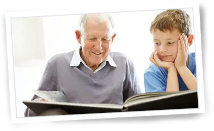 grandfather reading book to grandson